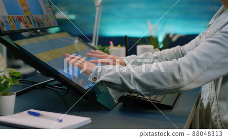 Close up of photographer hands using touch screen monitor on retouching software for pictures design at studio. Media artist editing photos with professional app in photography office Close up of photographer hands using touch screen monitor on retouching software for pictures design at studio. Media artist editing photos with professional app in photography office 88048313