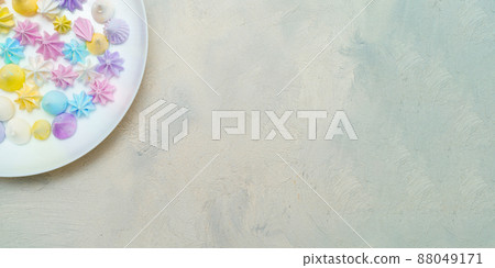 Top view of part plate with delicious colorful meringue cookies. Sweet decor. Confectionery  88049171
