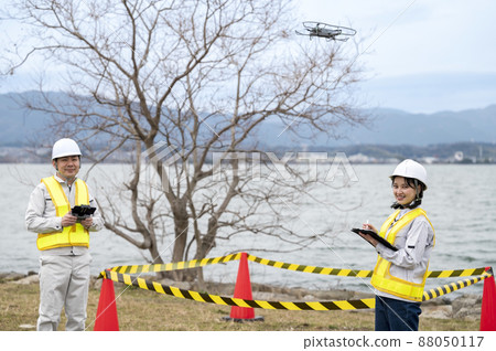 Workers operating drones 88050117