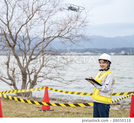 Workers operating drones 88050118