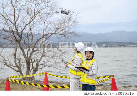 Workers operating drones 88050119