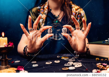 Astrology and horoscope. A woman holds stones with the zodiac sign of Taurus and Sagittarius. The concept of compatibility of partners according to the signs of the zodiac Astrology and horoscope. A woman holds stones with the zodiac sign of Taurus and Sagittarius. The concept of compatibility of partners according to the signs of the zodiac 88050132