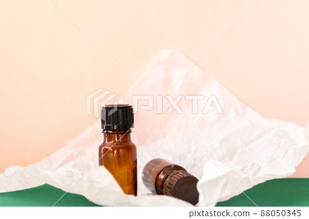 Aroma oil glass bottle with torn paper, skin care products Aroma oil glass bottle with torn paper, skin care products 88050345