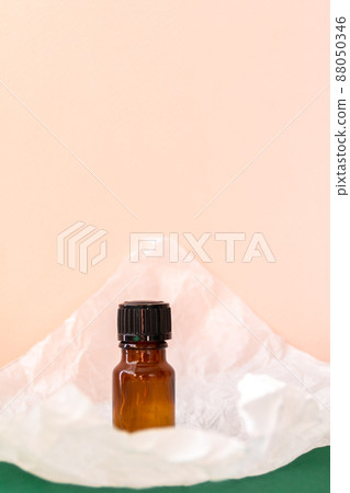 Aroma oil glass bottle with torn paper, skin care products Aroma oil glass bottle with torn paper, skin care products 88050346