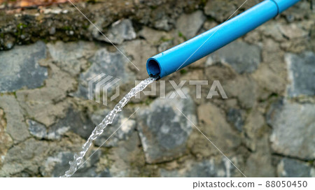 Water running from a blue water pipe, equipment agriculture. 88050450