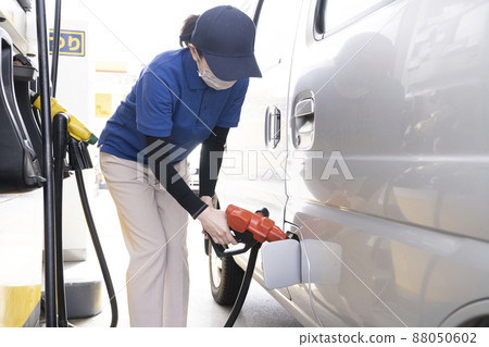 Hands of a woman refueling at a self-service gas station Hands of a woman refueling at a self-service gas station 88050602
