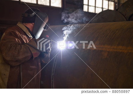 welder performs welding large diameter pipe welder performs welding large diameter pipe 88050897