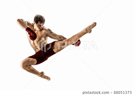 Full size of athlete boxer who perform muay thai martial arts on white background. Red sportswear Full size of athlete boxer who perform muay thai martial arts on white background. Red sportswear 88051373