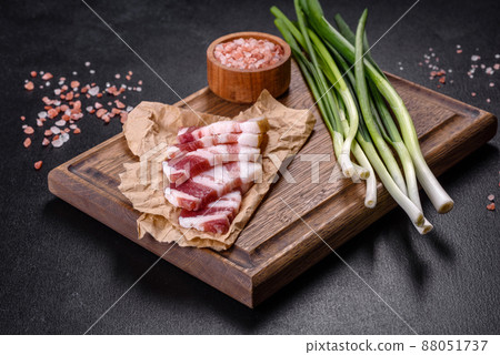 Fresh delicious pork lard with green onions on a wooden cutting board 88051737