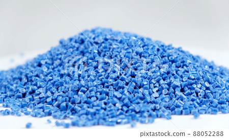 Secondary granule made of polypropylene, Blue Plastic pellets crumbles to the table. Plastic raw materials in granules for industry. Polymer resin. Raw plastic recycling concept 88052288