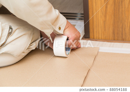 Workers laying a drop clothes 88054188