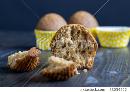 delicious wheat cupcakes on a black wooden table delicious wheat cupcakes on a black wooden table 88054322