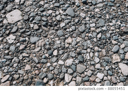 Stones on the shore. Sandy shore. The texture of the stones. Small pebbles on the beach. Stones on the shore. Sandy shore. The texture of the stones. Small pebbles on the beach. 88055451