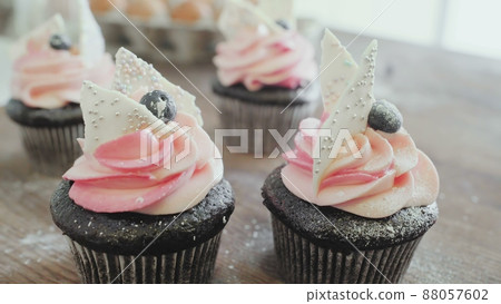 Close-up of beautiful and delicious cupcakes on the kitchen table Close-up of beautiful and delicious cupcakes on the kitchen table 88057602