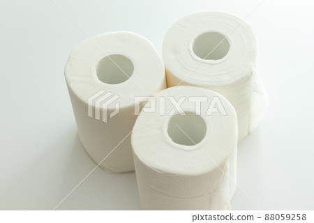 Three toilet papers on a white table Three toilet papers on a white table 88059258