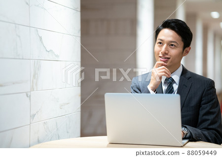 A businessman working in a shared office 88059449