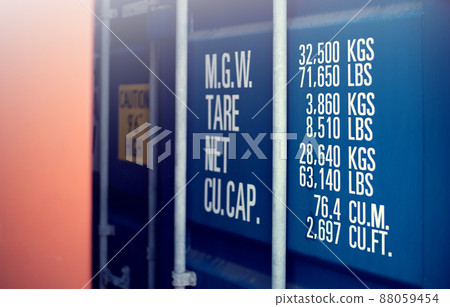 Perspective close up of a blue container's door with the measures and the weight. Perspective close up of a blue container's door with the measures and the weight. 88059454