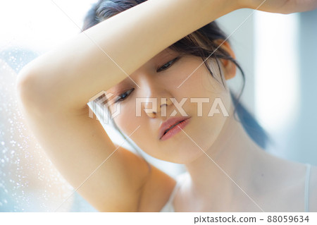 A woman by the window A woman by the window 88059634