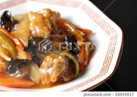Photographed hot vinegared pork served on an octagonal Chinese plate on a black background Photographed hot vinegared pork served on an octagonal Chinese plate on a black background 88059917