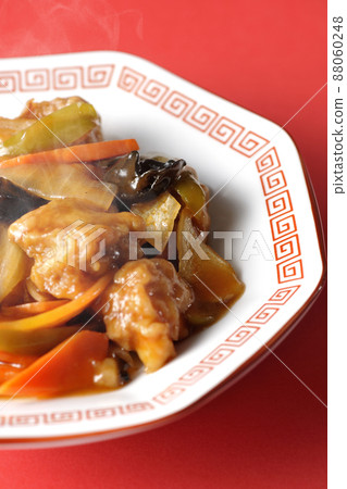 Photographed hot vinegar pork served on an octagonal Chinese plate against a red background Photographed hot vinegar pork served on an octagonal Chinese plate against a red background 88060248