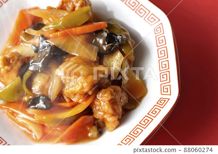 A bird's-eye view of the hot vinegared pork served on an octagonal Chinese plate against a red background A bird's-eye view of the hot vinegared pork served on an octagonal Chinese plate against a red background 88060274