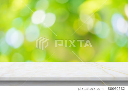Marble table top with blur green leaf bokeh nature background 88060582