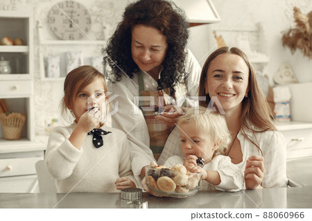 Big family eats cookies at home 88060966