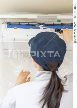 Woman working in air conditioner cleaning Woman working in air conditioner cleaning 88061022