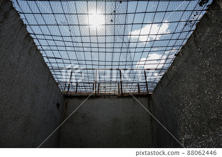 View of the blue sky through the bars of the prison cell View of the blue sky through the bars of the prison cell 88062446