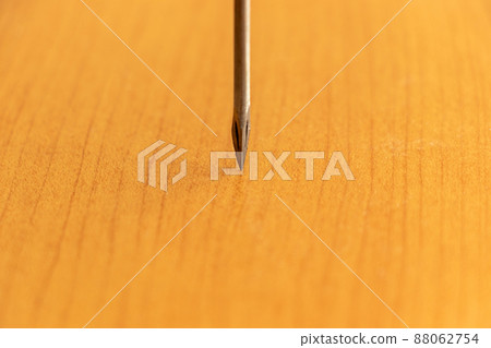 The tip of a sharp drill struck against wood 88062754