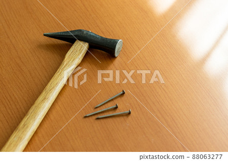 Hammer and iron nails placed by the window Hammer and iron nails placed by the window 88063277