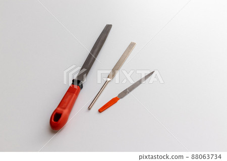 Three iron files on a white desk 88063734