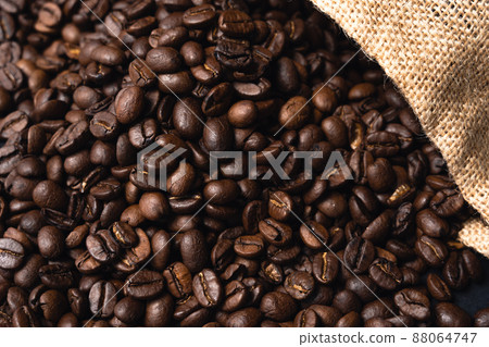 Roasted coffee beans and jute bags Roasted coffee beans and jute bags 88064747