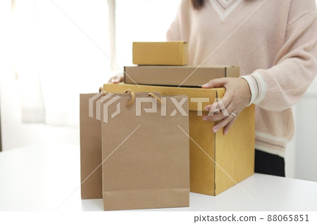 Business From Home woman preparing package delivery box Shipping for shopping online. young start up small business owner at home online order shopping 88065851