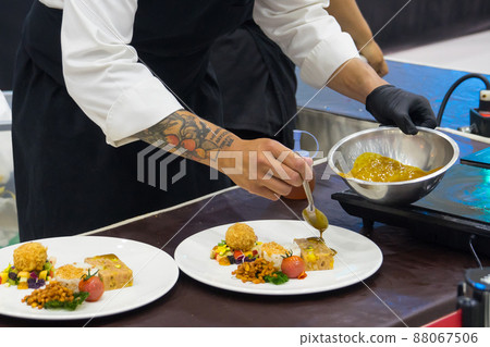 Chef in hotel or restaurant kitchen cooking 88067506