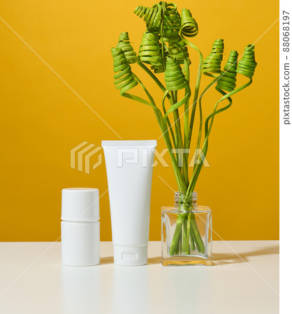 empty white plastic tubes and jars for cosmetics. Packaging for cream, gel, serum, advertising and product promotion 88068197