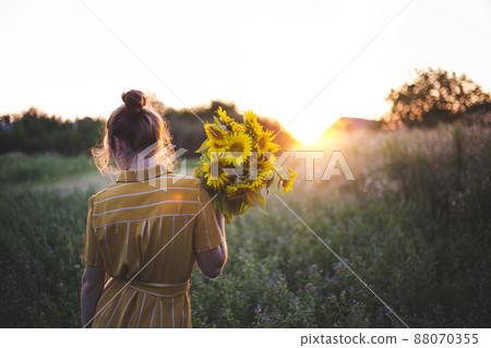 Girl and sunflowers 88070355