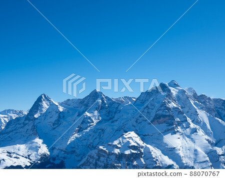 Winter view from Schilthorn peak, Switzerland, towards the famous mountains Eiger, Moench, and Jungfrau Winter view from Schilthorn peak, Switzerland, towards the famous mountains Eiger, Moench, and Jungfrau 88070767