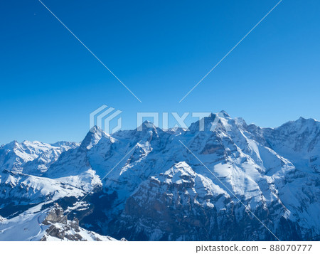 Winter view from Schilthorn peak, Switzerland, towards the famous mountains Eiger, Moench, and Jungfrau Winter view from Schilthorn peak, Switzerland, towards the famous mountains Eiger, Moench, and Jungfrau 88070777