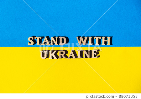 Ukrainian national flag made of paper. STAND WITH UKRAINE text. Stop War. The concept of ending the war in Ukraine. National symbol - blue and yellow. War Protest against Russian invasion of Ukraine. 88073355