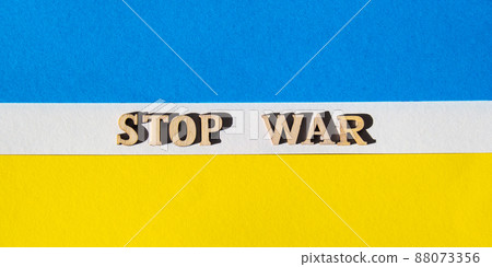 Ukrainian national flag made of paper. STOP WAR text. The concept of ending the war in Ukraine. National symbol - blue and yellow. War Protest against Russian invasion of Ukraine. Banner size 88073356
