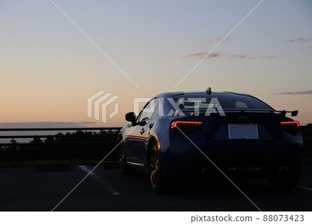 Sports car parked in the parking lot at dusk 88073423