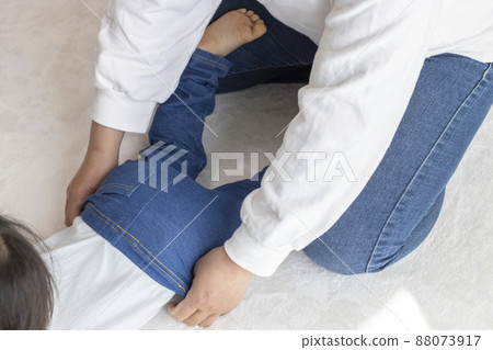 Mother changing clothes for baby (1 year and 8 months old, girl, Japanese) 88073917