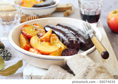 Traditional French cuisine: fried blood sausage and apples  88074838