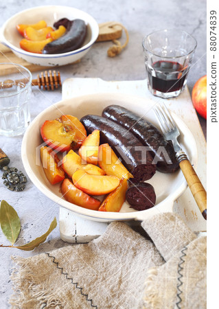 Traditional French cuisine: fried blood sausage and apples 88074839