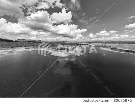 Feathery Clouds Mirrored In The Calm Water Of A Dam 88075976