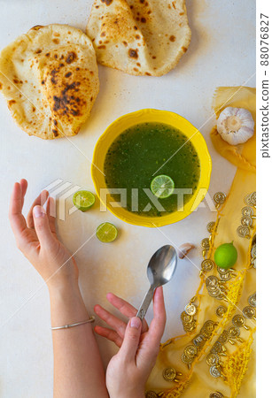 Woman eating Molokhia soup flat lay 88076827