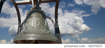 Orthodox bells closeup against the sky with clouds. New Jerusalem in town Istra, surroundings of Moscow, Russia. Orthodox bells closeup against the sky with clouds. New Jerusalem in town Istra, surroundings of Moscow, Russia. 88076925