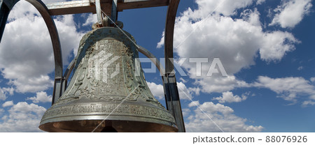 Orthodox bells closeup against the sky with clouds. New Jerusalem in town Istra, surroundings of Moscow, Russia. Orthodox bells closeup against the sky with clouds. New Jerusalem in town Istra, surroundings of Moscow, Russia. 88076926