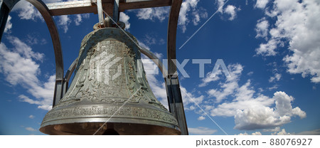 Orthodox bells closeup against the sky with clouds. New Jerusalem in town Istra, surroundings of Moscow, Russia. Orthodox bells closeup against the sky with clouds. New Jerusalem in town Istra, surroundings of Moscow, Russia. 88076927